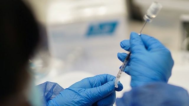 A health care worker prepares a booster dose of the Pfizer-BioNTech coronavirus disease (COVID-19) vaccine in Montevideo, Uruguay August 16, 2021.