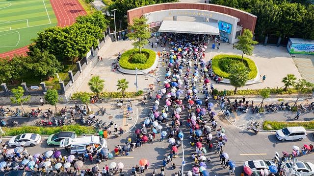 Aerial view of local residents queue up for COVID-19 nucleic acid testing at a primary school on September 14, 2021 in Xiamen, Fujian Province of China