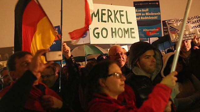 Supporters of the AfD political party protest against German Chancellor Angela Merkel's liberal policy towards taking in migrants and refugees