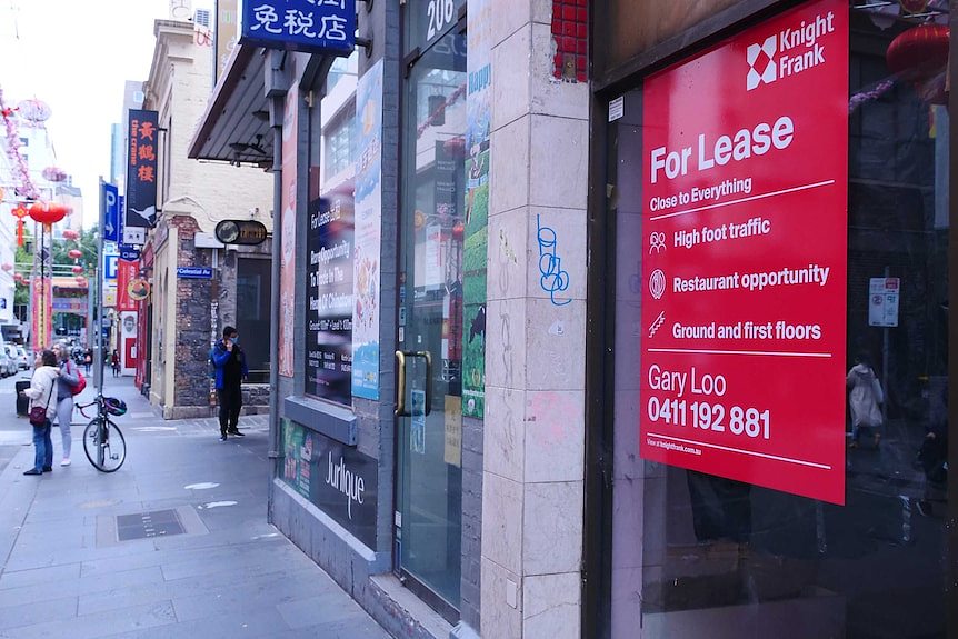 A big red for lease sign displayed on a shopfront in Chinatown, the next shop also has a for lease