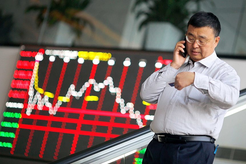 Chinese investor on the phone as market falls