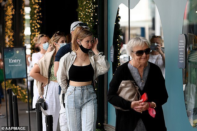 Professor Williams said a booster program will be absolutely vital to maintain protection among the population before the country heads into winter (pictured, shoppers view Christmas displays at Sydney's David Jones department store)