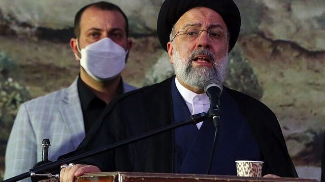 Ebrahim Raisi speaking from a podium