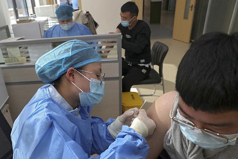 中国江苏，医护人员在给一民众施打国药集团的新冠疫苗。(美联社)