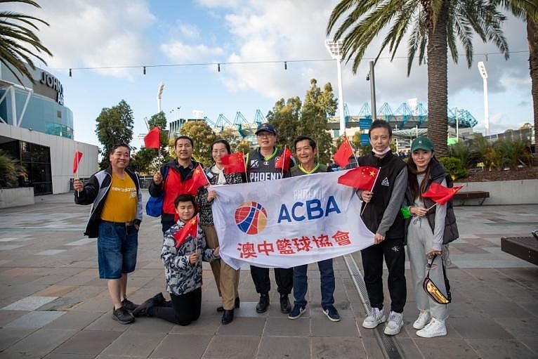 A group of people holding a sign

Description automatically generated