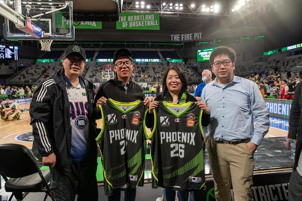 A group of people posing for a photo in a stadium

Description automatically generated with medium confidence