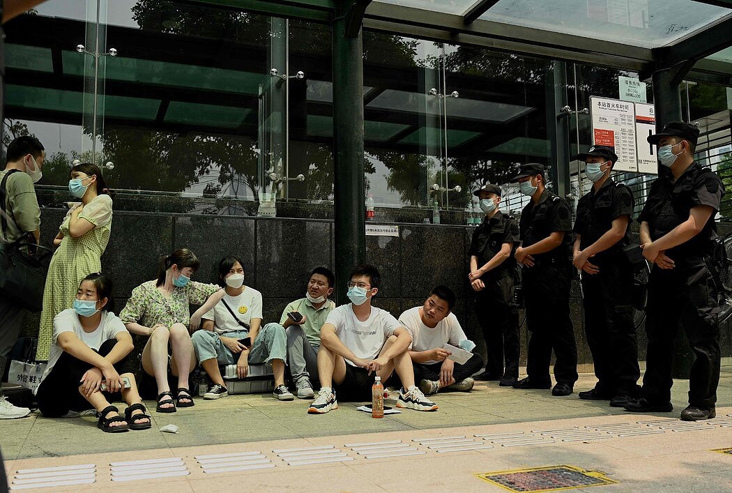在去年9月的抗议活动期间等待在恒大深圳总部大楼外的人们。