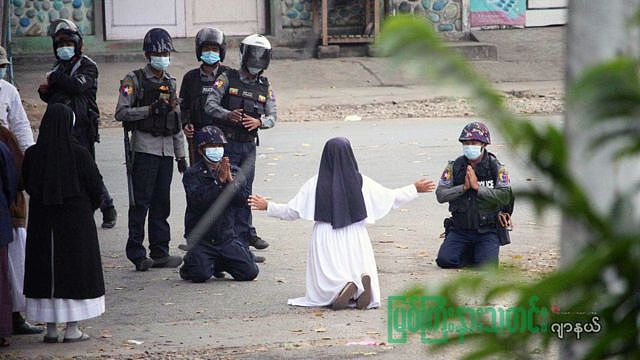 Sister Ann Rose Nu Tawng kneeling before police in March 2021