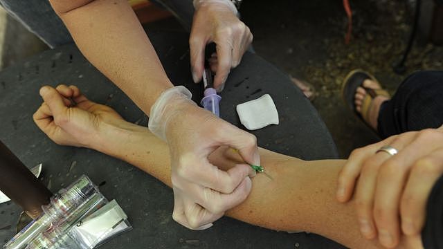 Olympic athletes has a blood test in her forearm