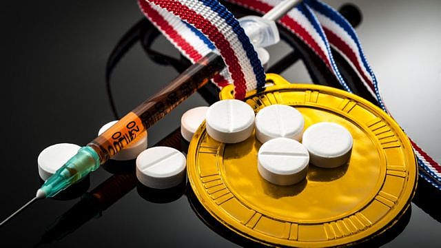 Olympic gold medal pills and a syringe