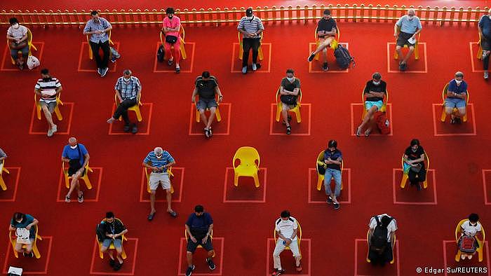 People watch an outdoor movie screening within their social distances in Singapore