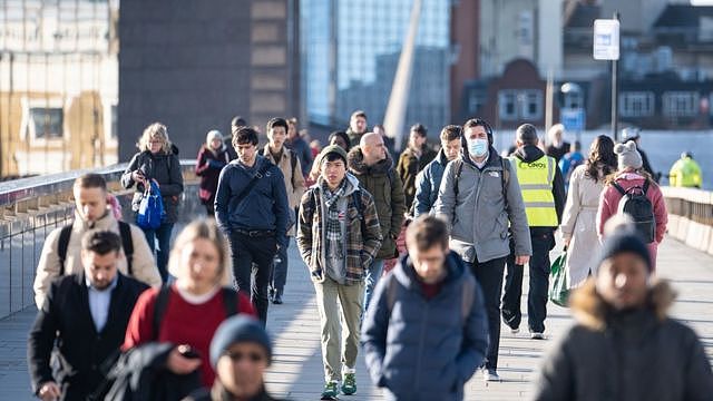 Commuters walk across London Bridge, in central London. The government has said it intends to lift all remaining Covid restrictions in England - including the legal rule to self-isolate - later this month. Picture date: Monday February 14, 2022.