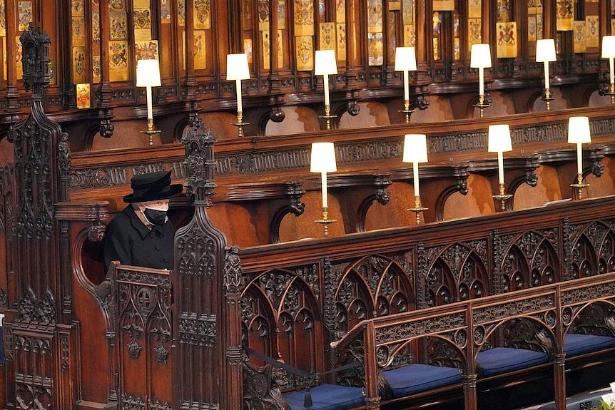 The Queen sits alone at Prince Philip's funeral.