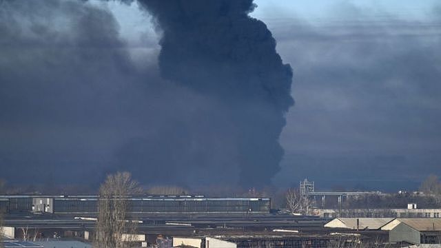 Black smoke rises from a military airport in Chuhuyev near Kharkiv on February 24, 2022