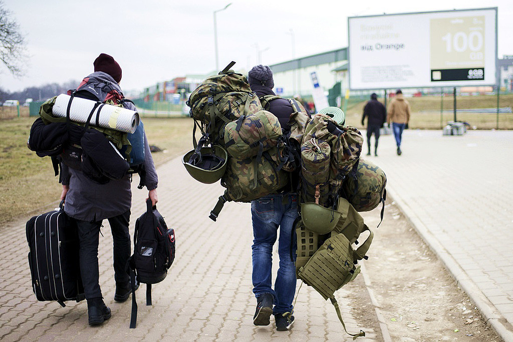 外国志愿者透露，乌克兰号召的国际军团内部一片混乱。 图为从波兰边境城市米迪卡（Medyka）进入乌克兰的外国战士。 （图／美联社）