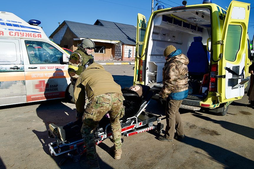 An elderly resident of Irpin is loaded into an ambulance.