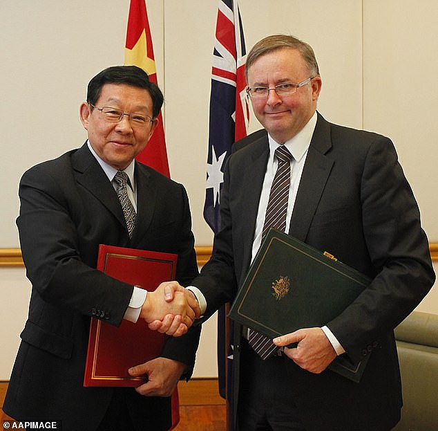Anthony Albanese (right) shakes hands with China's then commerce minister Chen Deming (left) at Parliament House in Canberra on Tuesday, April 10, 2012. Mr Albanese now sees China as 'a serious threat' to Australia's security