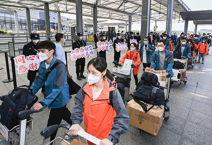 近日，部分援沪核酸检测队开始陆续撤离返回。图为5月14日，撤离上海的湖北省援沪核酸检测队队员们排队进入航站楼准备登机。新华社记者 李贺 摄