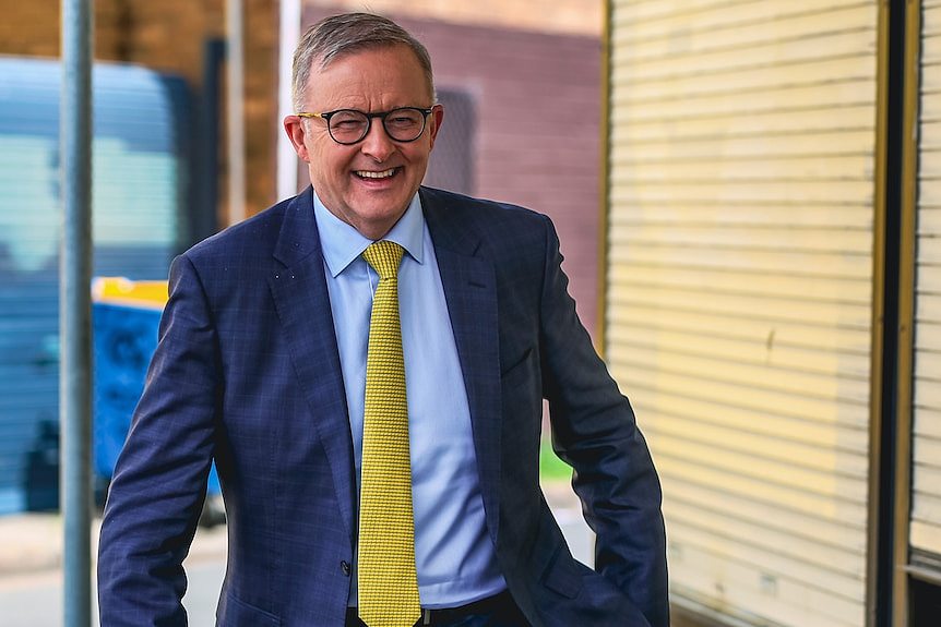 Opposition leader Anthony Albanese smiles walking along. 