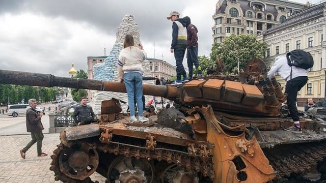 People look at destroyed Russian armored vehicles displayed for Ukrainians to see at Mykhailivska Square in downtown Kyiv, Ukraine, May 22, 2022