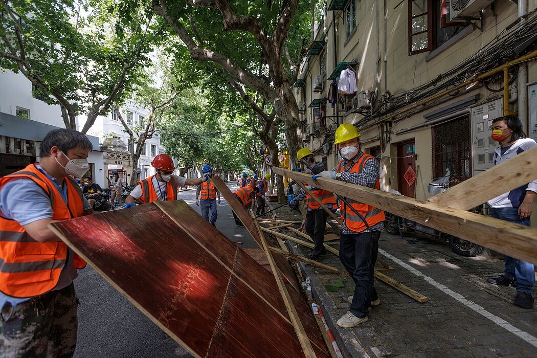 工人拆除在上海封控期间将居民限制在小区里的障碍物。