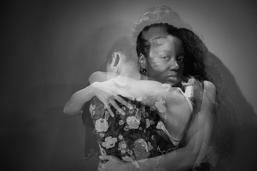 A double exposure photograph of two women embracing.