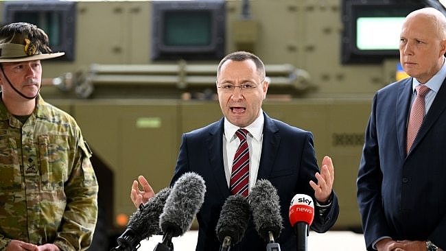 Ukrainian Ambassador Vasyl Myroshnychenko (centre) with then-defence minister Peter Dutton in Ipswich in April following the government's announcement that it would send 20 Bushmasters to the war-zone in Ukraine. Picture: Getty Images