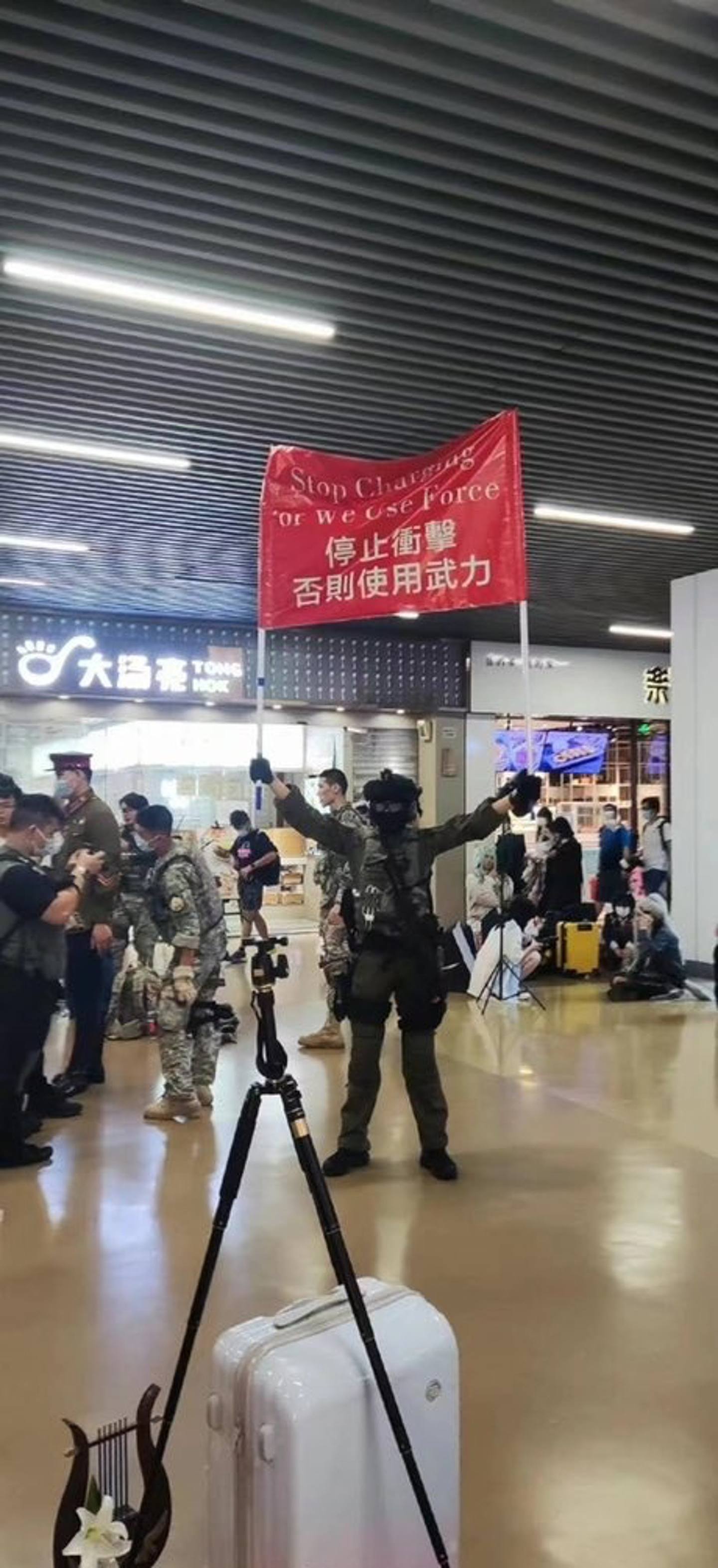 有网民表示，7月15日广州漫展上有「小粉红」举着红旗「「停止冲击，否则使用武力」」角色扮演（Cosplay）香港警察，结果被当地公安警告，没收红旗，（Twitter@Jacobson贴贴BOT）
