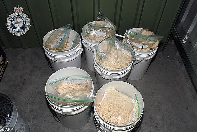 During a raid of the group's custom 'cocaine factory' they found plastic buckets containing cocaine hidden in an unknown substance (above)