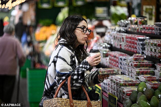 Australian households are expected to take a hit after a sharp rise in annual inflation to 6.1 per cent, its highest rate in 21 years (pictured are shoppers at a Melbourne market)