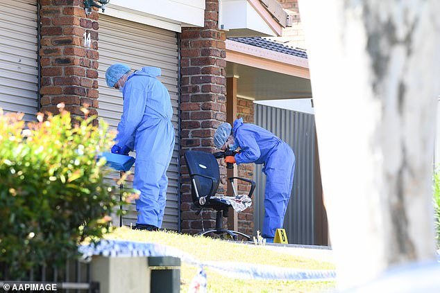 Forensic officers spent much of Monday at the home scouring for clues and photographing evidence outside the front of the double garage