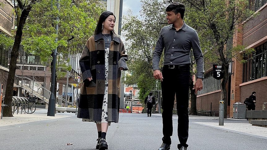 Jinru Sun and Bhavya Bagaria talk as they walk down a campus street