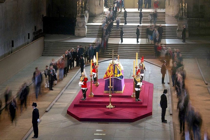 Mourners file past the coffin of the Queen Mother as she lies in state in Westminster Hall.