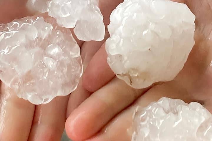 Close up photo of hands holding very large hail