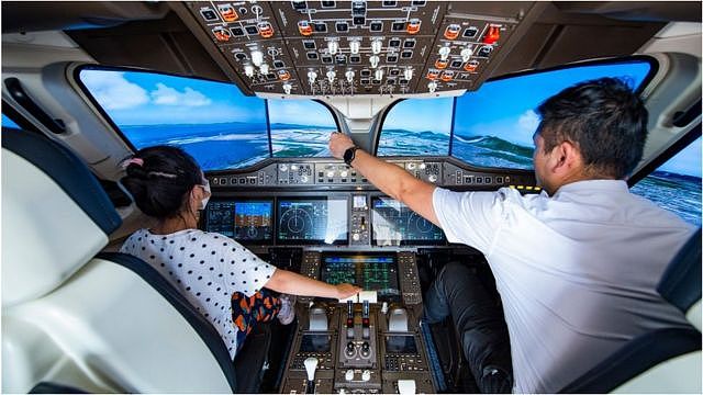 A child experiences a simulated cockpit of China's domestically-made C919 jet during 2022 Beijing Science and Technology Week on August 21, 2022 in Beijing, China