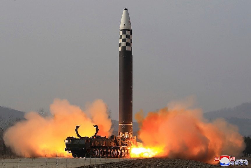 A large missile is seen taking off from the back of a truck