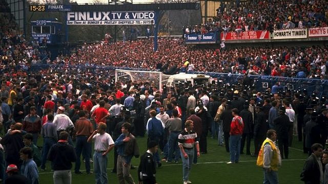 Police, medical staff and fans on the pitch at Hillsborough