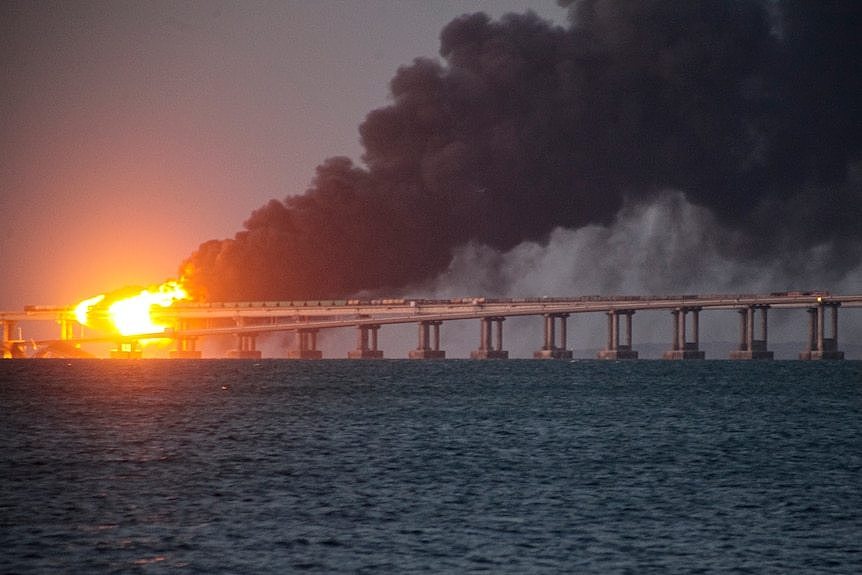 Fire and a plume of smoke on the bridge.