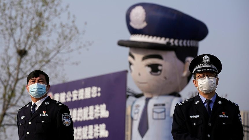 Two police men standing on the street of Beijing.