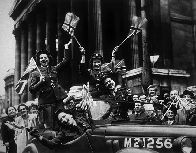 Members of the Auxiliary Territorial Service (ATS) , driving through Trafalgar Square in a service vehicle during the VE Day celebrations in London, 8th May 1945