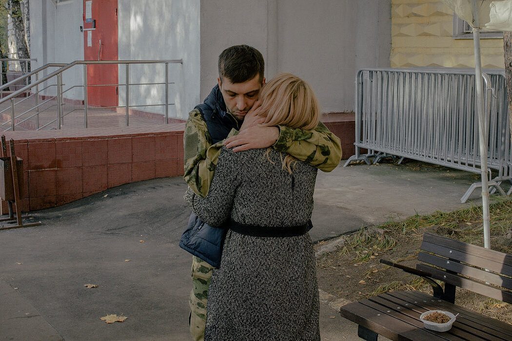 在莫斯科的征兵处，一名俄罗斯应征军人拥抱了他的伴侣。