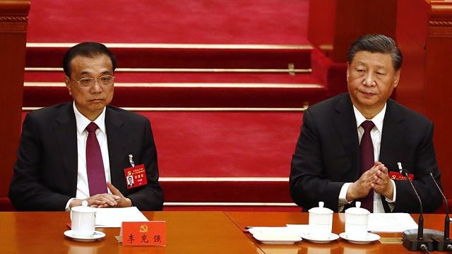 Chinese President Xi Jinping (R) reacts next to Premier Li Keqiang (L) during the closing ceremony of the 20th National Congress of the Communist Party of China (CPC) at the Great Hall of People in Beijing, China, 22 October 202