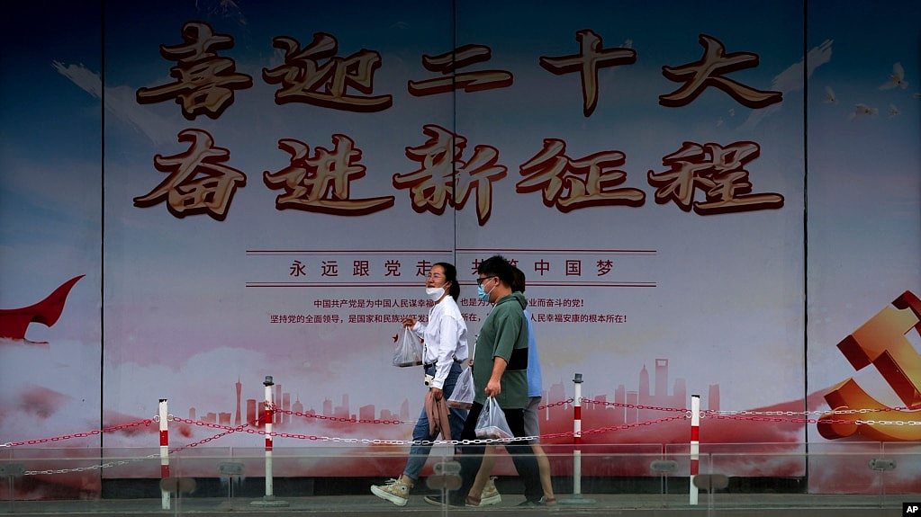 行人走過北京街頭豎立的中共二十大宣傳牌。（2022年8月17日）