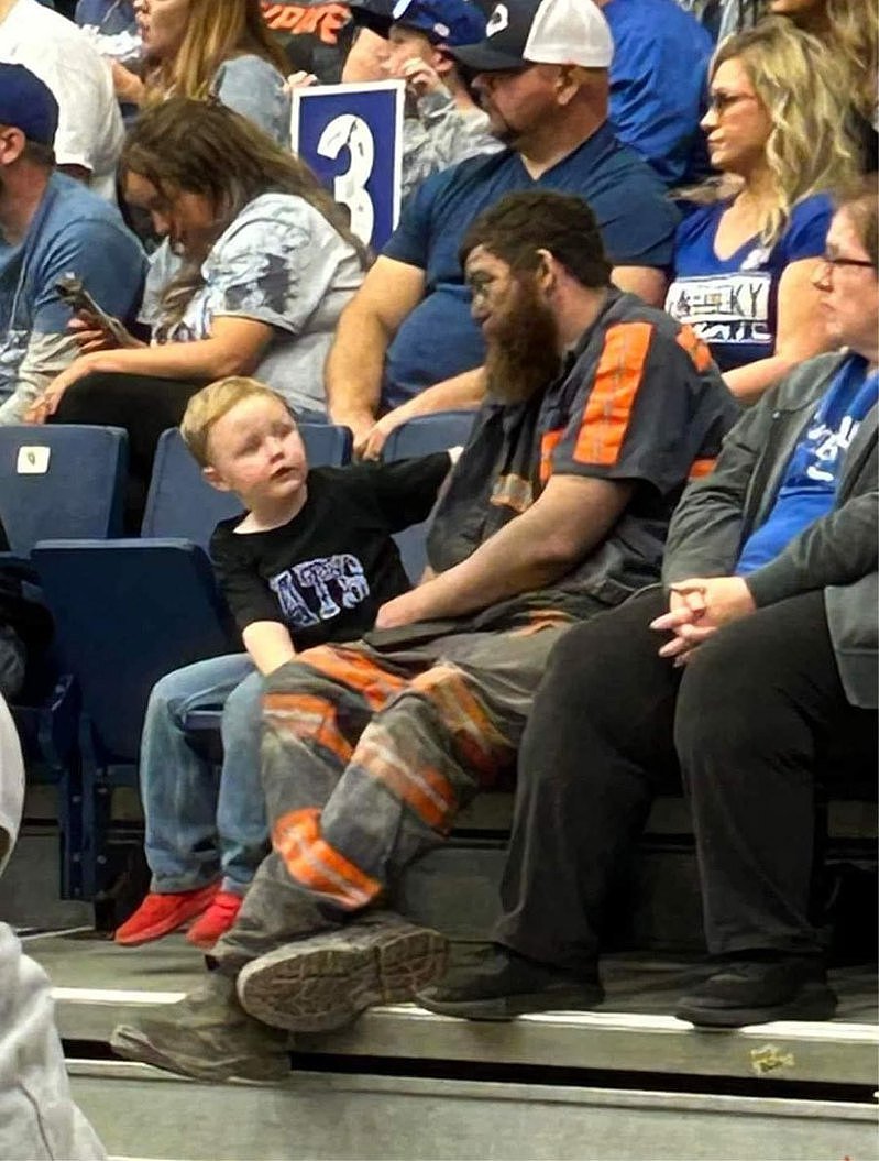 美國一礦工工人穿著制服和工作鞋陪兒子一起看籃球賽。圖擷自推特