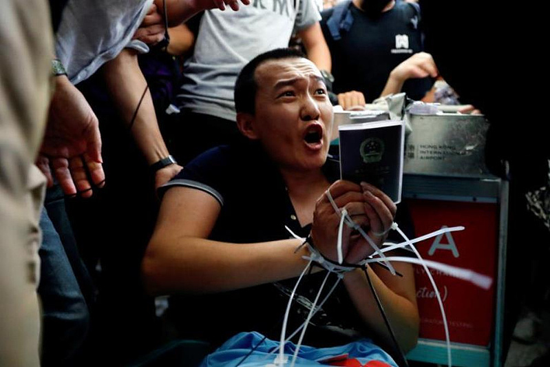 被中國大陸稱為「愛國記者」的付國豪2019年8月被香港機場內的暴徒圍毆，雙手被束帶綑綁。（路透資料照片）