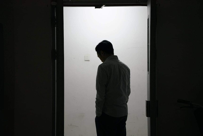 A silhouette of a man in a doorway. 