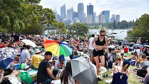 People are seen at Mrs Macquarie's Point in preparation for New Years Eve Fireworks last year.