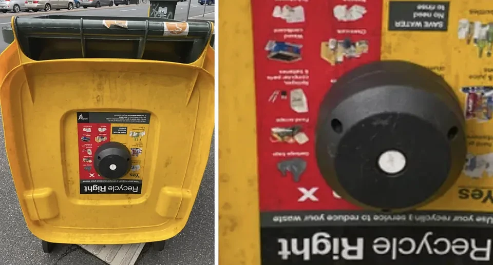 The recycling bin with a black device on the inside of the yellow lid.