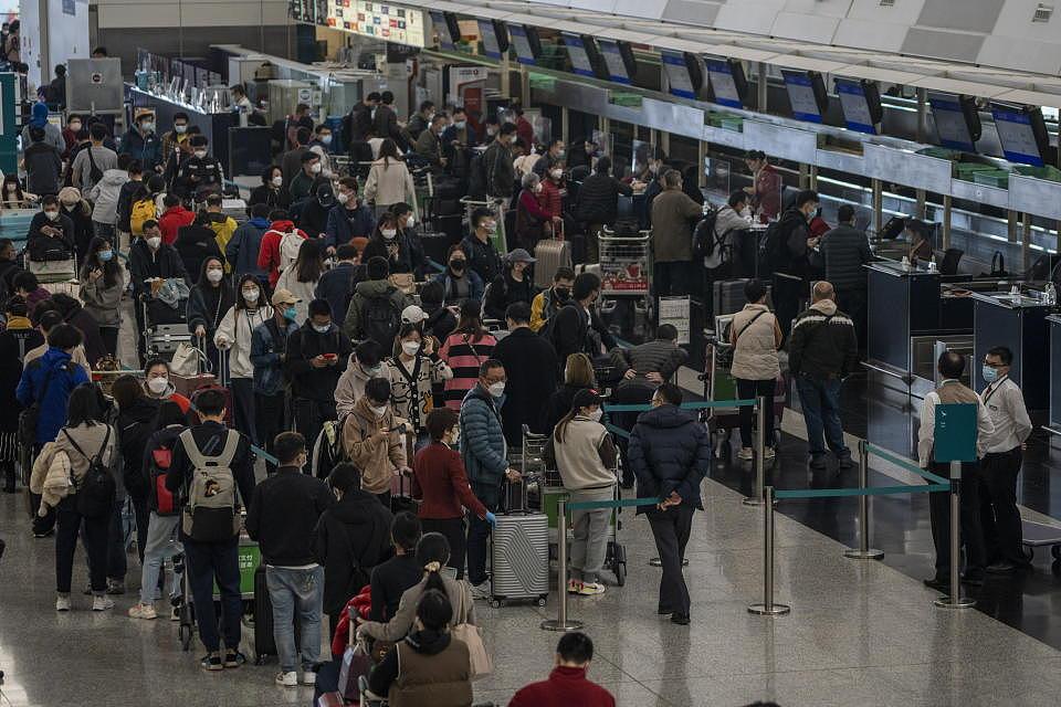 Travelers waiting in line to check in inside Terminal 1 at the Hong Kong International Airport on December 20, 2022 in Hong Kong, China. (Photo by Vernon Yuen/NurPhoto via Getty Images)