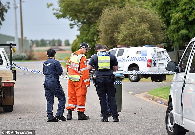 A young woman has been left fighting for life after she was found on fire in the front yard of a Melbourne home following a dispute (pictured, emergency services at the scene)